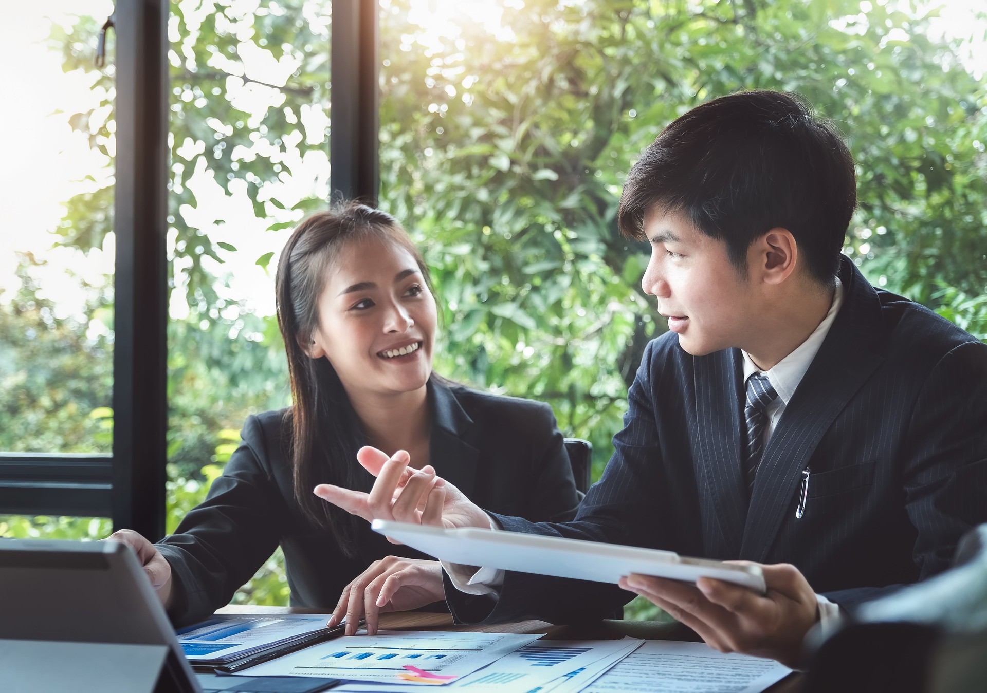 A  business man consultant describes a marketing plan to set business strategies for women business owners. business budget planning and business researching concept.a